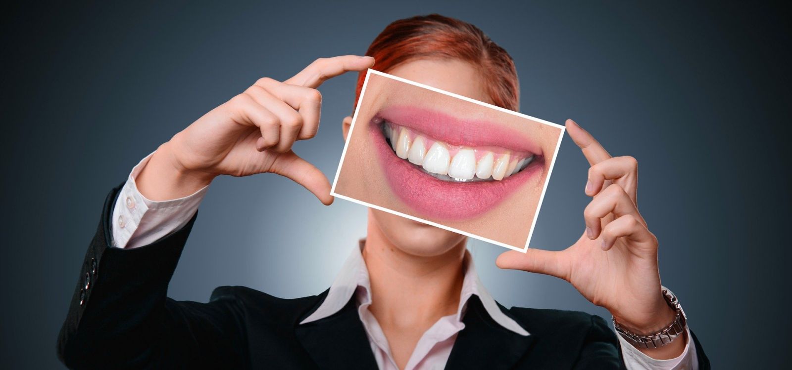 woman holding picture of straight teeth in front of her face